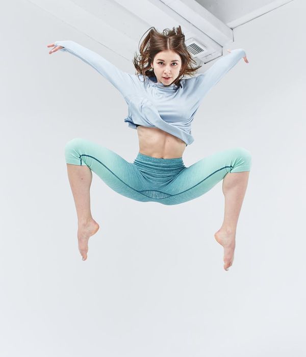 Woman in a dynamic cardio pose, feeling energetic.